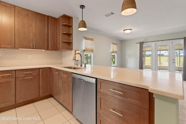 47 Anchor Dr, Indian Harbour Beach, FL 32937 - kitchen featuring stainless steel dishwasher, a peninsula, plenty of natural light, and backsplash