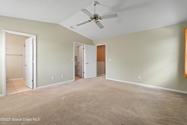 47 Anchor Dr, Indian Harbour Beach, FL 32937 - unfurnished bedroom featuring lofted ceiling, light colored carpet, ensuite bathroom, a walk in closet, and ceiling fan