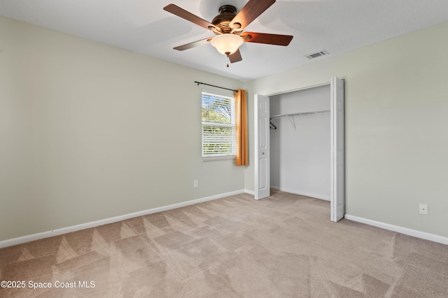 47 Anchor Dr, Indian Harbour Beach, FL 32937 - unfurnished bedroom with light colored carpet, a closet, and a ceiling fan