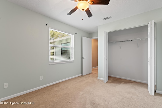 47 Anchor Dr, Indian Harbour Beach, FL 32937 - unfurnished bedroom with carpet, a closet, and a ceiling fan