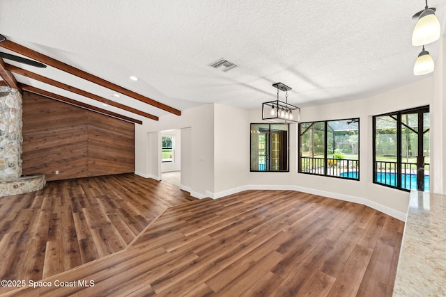 2150 Winston Dr, Cocoa, FL 32926 - unfurnished living room with wood finished floors, a textured ceiling, recessed lighting, and a chandelier