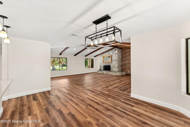 2150 Winston Dr, Cocoa, FL 32926 - unfurnished living room featuring a fireplace, wood finished floors, and a textured ceiling