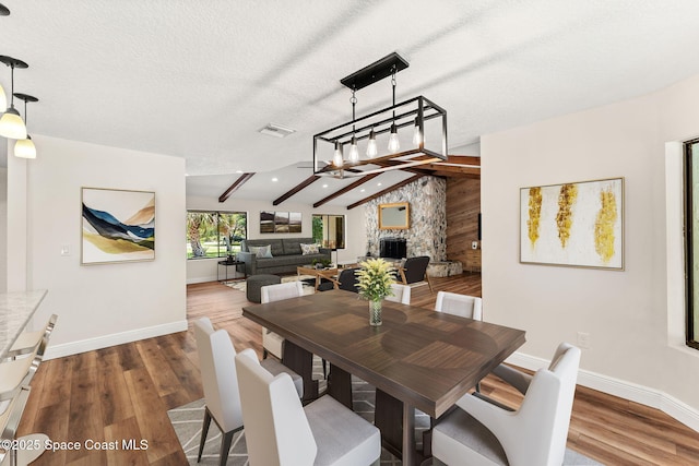 2150 Winston Dr, Cocoa, FL 32926 - dining room featuring wood finished floors, a fireplace, and a textured ceiling