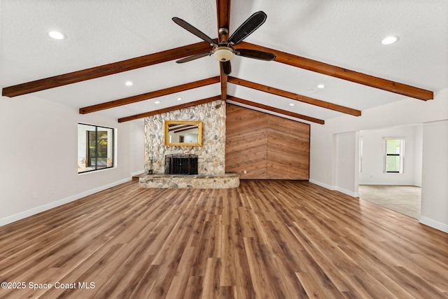 2150 Winston Dr, Cocoa, FL 32926 - unfurnished living room with recessed lighting, ceiling fan, a textured ceiling, wood finished floors, and a fireplace