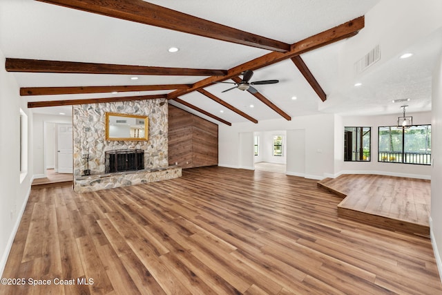 2150 Winston Dr, Cocoa, FL 32926 - unfurnished living room featuring recessed lighting, light wood-style flooring, a stone fireplace, and a ceiling fan