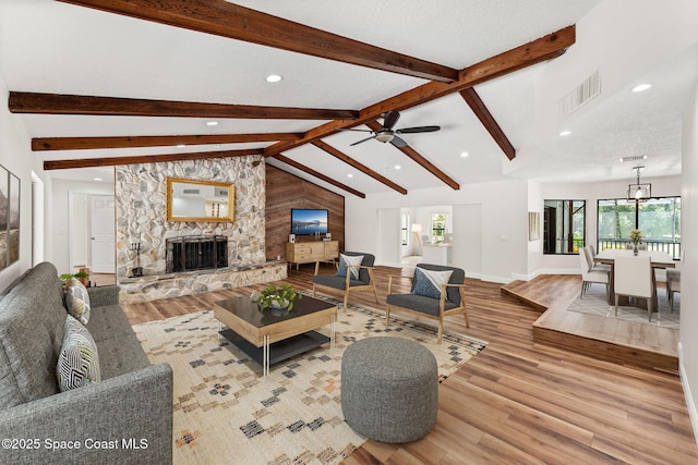2150 Winston Dr, Cocoa, FL 32926 - living room featuring recessed lighting, wood finished floors, a stone fireplace, and a ceiling fan