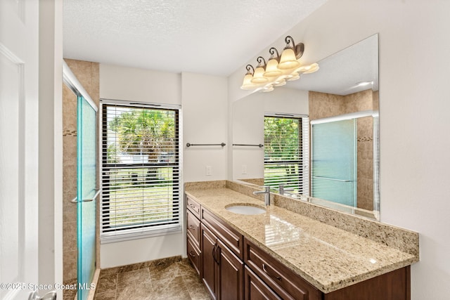 2150 Winston Dr, Cocoa, FL 32926 - bathroom with vanity, plenty of natural light, a stall shower, a textured ceiling, and tile patterned flooring