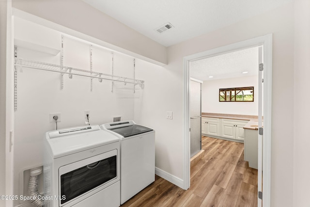 2150 Winston Dr, Cocoa, FL 32926 - laundry area featuring washer and dryer and light wood finished floors