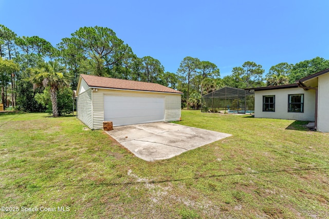 2150 Winston Dr, Cocoa, FL 32926 - view of grassy yard featuring an outbuilding, a garage, glass enclosure, and a swimming pool