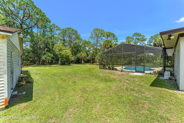 2150 Winston Dr, Cocoa, FL 32926 - view of green lawn with an outdoor pool and a lanai
