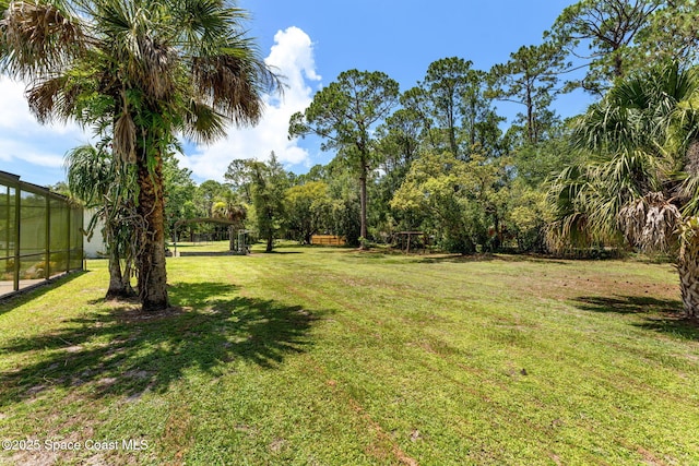 2150 Winston Dr, Cocoa, FL 32926 - view of grassy yard featuring a lanai