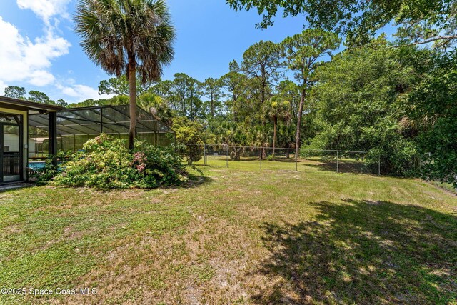 2150 Winston Dr, Cocoa, FL 32926 - fenced backyard featuring glass enclosure