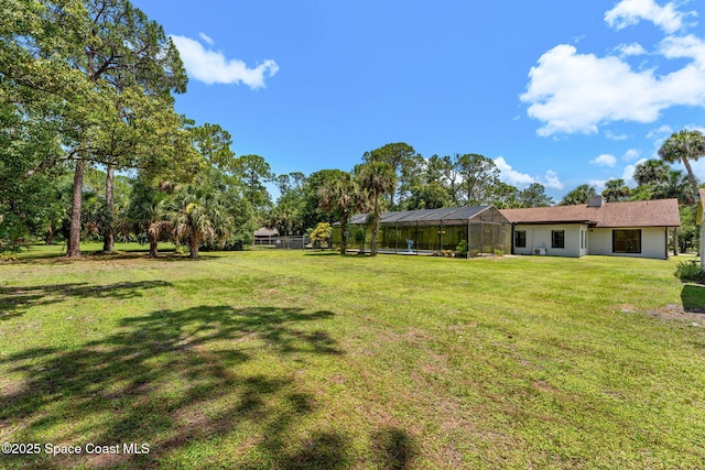 2150 Winston Dr, Cocoa, FL 32926 - view of grassy yard with a lanai
