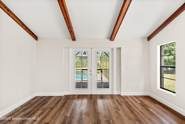 2150 Winston Dr, Cocoa, FL 32926 - spare room with french doors, healthy amount of natural light, beamed ceiling, wood finished floors, and a textured ceiling