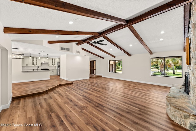 2150 Winston Dr, Cocoa, FL 32926 - unfurnished living room featuring wood finished floors, recessed lighting, a textured ceiling, a ceiling fan, and healthy amount of natural light
