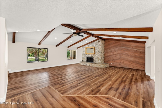 2150 Winston Dr, Cocoa, FL 32926 - unfurnished living room with wood finished floors, a fireplace, ceiling fan, recessed lighting, and a textured ceiling