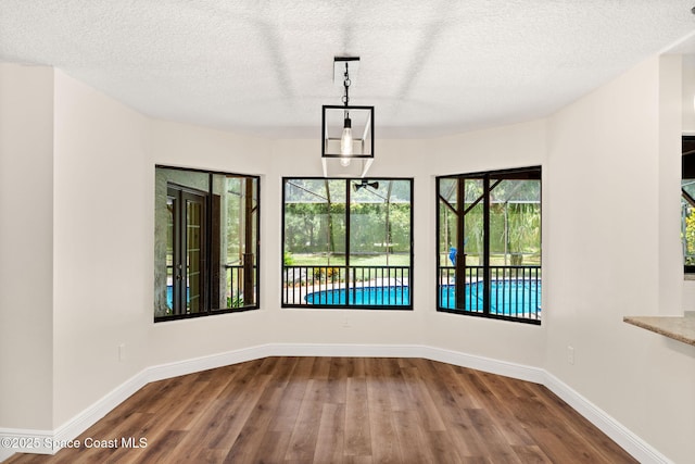2150 Winston Dr, Cocoa, FL 32926 - unfurnished dining area featuring wood finished floors and a textured ceiling