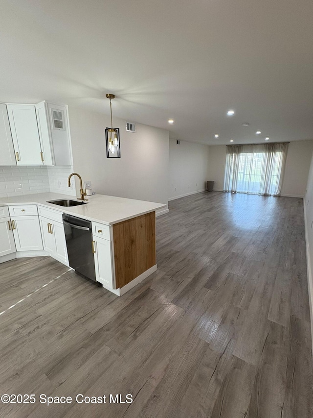 1515 Huntington Ln Unit 915, Rockledge, FL 32955 - kitchen featuring stainless steel dishwasher, a peninsula, open floor plan, white cabinetry, and recessed lighting