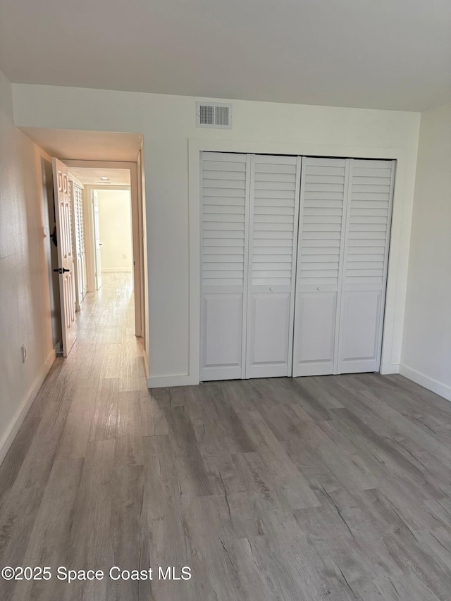 1515 Huntington Ln Unit 915, Rockledge, FL 32955 - unfurnished bedroom featuring wood finished floors and a closet