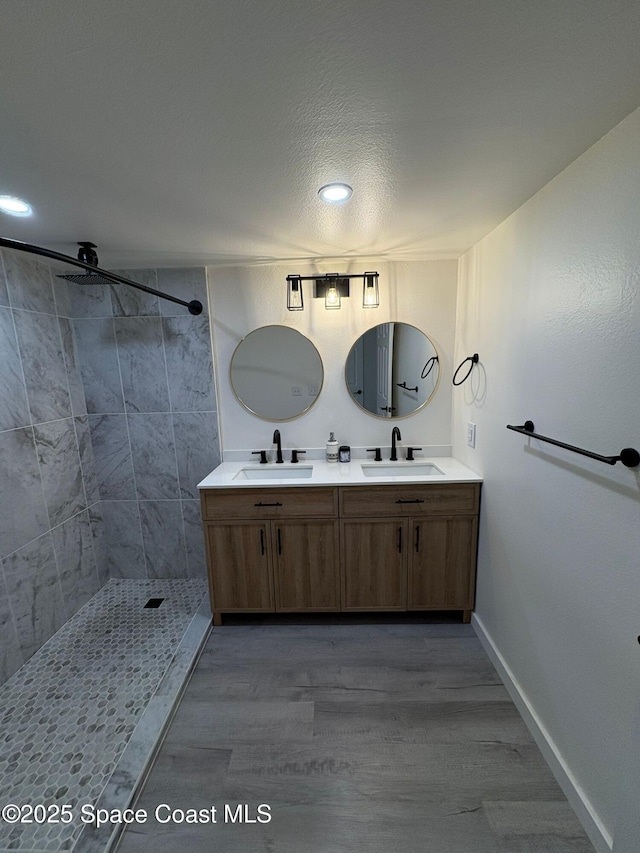 1515 Huntington Ln Unit 915, Rockledge, FL 32955 - bathroom with double vanity, wood finished floors, tiled shower, and recessed lighting