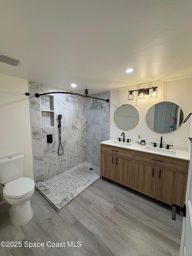 1515 Huntington Ln Unit 915, Rockledge, FL 32955 - full bath with wood finished floors, double vanity, a tile shower, and recessed lighting