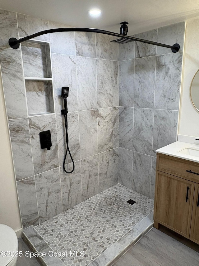 1515 Huntington Ln Unit 915, Rockledge, FL 32955 - bathroom featuring vanity, a tile shower, recessed lighting, and wood finished floors