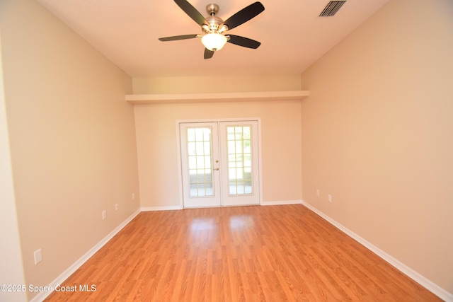 741 Pebble Ave NE, Palm Bay, FL 32907 - unfurnished room featuring light wood-type flooring, a ceiling fan, and french doors