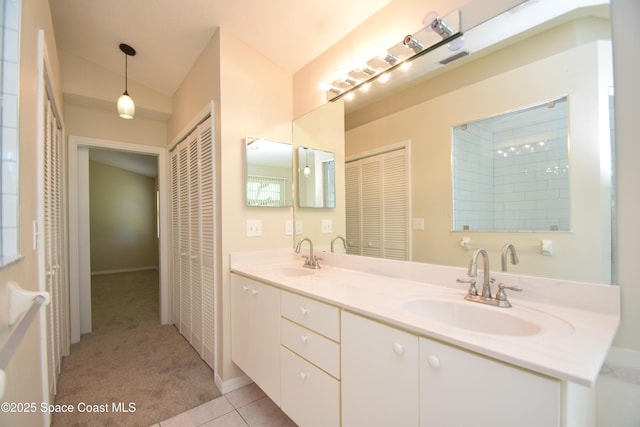 741 Pebble Ave NE, Palm Bay, FL 32907 - full bath with a closet, double vanity, tile patterned flooring, and vaulted ceiling