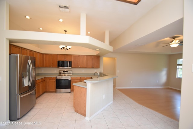 741 Pebble Ave NE, Palm Bay, FL 32907 - kitchen with appliances with stainless steel finishes, open floor plan, light countertops, recessed lighting, and a peninsula