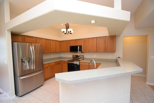 741 Pebble Ave NE, Palm Bay, FL 32907 - kitchen featuring appliances with stainless steel finishes, light tile patterned floors, light countertops, a peninsula, and a chandelier