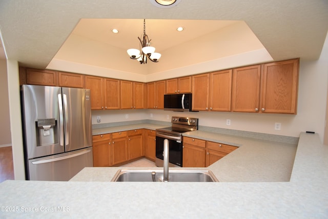741 Pebble Ave NE, Palm Bay, FL 32907 - kitchen featuring appliances with stainless steel finishes, a tray ceiling, a chandelier, light countertops, and recessed lighting