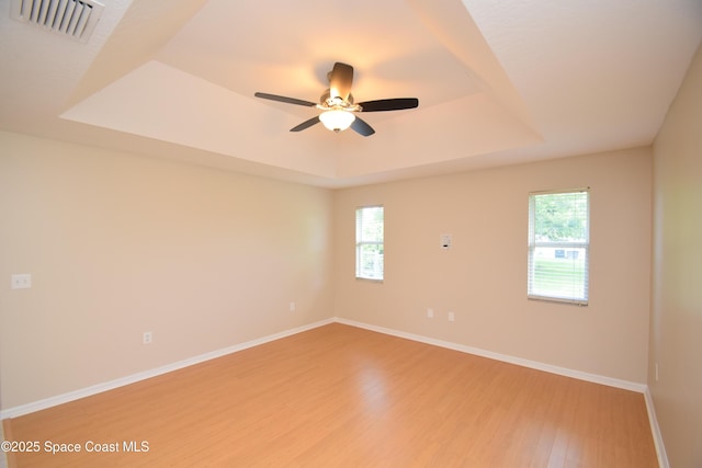 741 Pebble Ave NE, Palm Bay, FL 32907 - unfurnished room featuring a tray ceiling, light wood-type flooring, and a ceiling fan