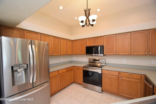 741 Pebble Ave NE, Palm Bay, FL 32907 - kitchen with stainless steel appliances, a chandelier, light tile patterned floors, light countertops, and recessed lighting