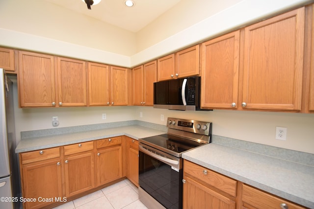 741 Pebble Ave NE, Palm Bay, FL 32907 - kitchen with stainless steel appliances, light tile patterned floors, light countertops, and recessed lighting
