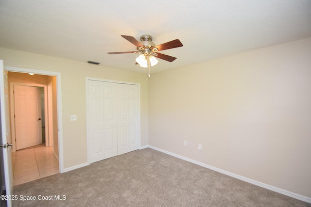 741 Pebble Ave NE, Palm Bay, FL 32907 - unfurnished bedroom with a closet, light carpet, and a ceiling fan
