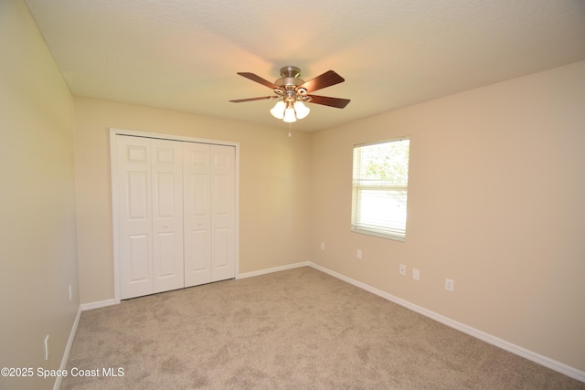 741 Pebble Ave NE, Palm Bay, FL 32907 - unfurnished bedroom with carpet, a closet, and ceiling fan