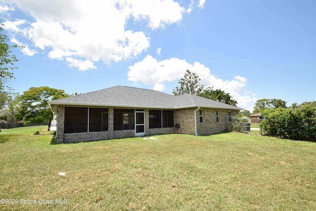 741 Pebble Ave NE, Palm Bay, FL 32907 - back of property with a yard, brick siding, and a sunroom