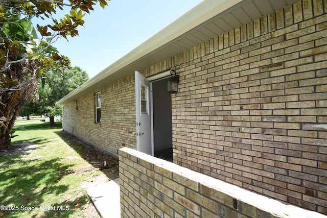 741 Pebble Ave NE, Palm Bay, FL 32907 - view of side of home with brick siding and a yard