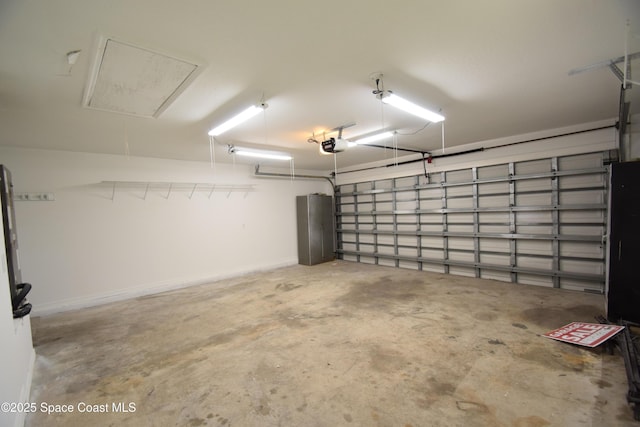 741 Pebble Ave NE, Palm Bay, FL 32907 - garage featuring a garage door opener and baseboards