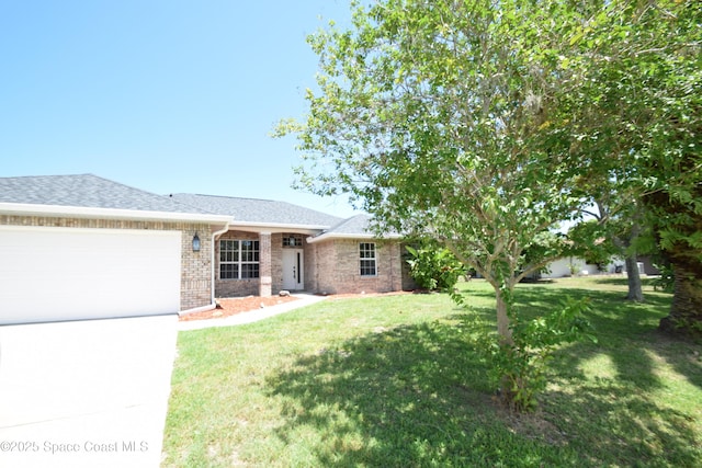 741 Pebble Ave NE, Palm Bay, FL 32907 - ranch-style house featuring a garage, brick siding, a front yard, and driveway