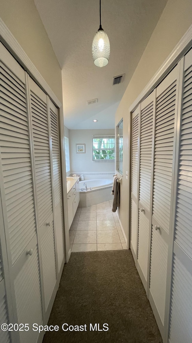 741 Pebble Ave NE, Palm Bay, FL 32907 - corridor with carpet flooring and tile patterned floors