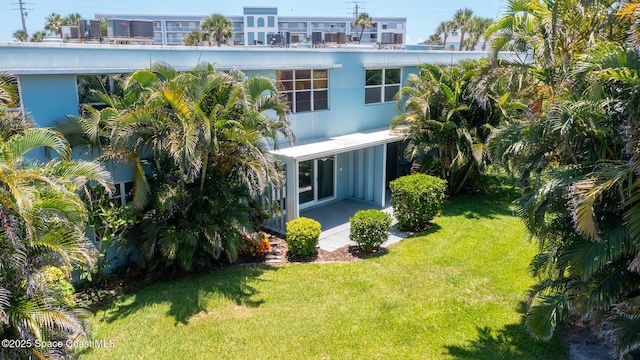 55 Sea Park Blvd Unit 206, Satellite Beach, FL 32937 - rear view of property featuring a yard