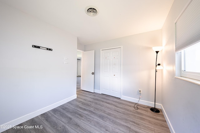 1384 Rosemary Dr, Melbourne, FL 32935 - unfurnished bedroom with wood finished floors and a closet