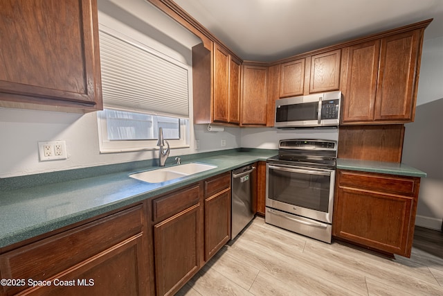 1384 Rosemary Dr, Melbourne, FL 32935 - kitchen with stainless steel appliances, dark countertops, and light wood-style flooring