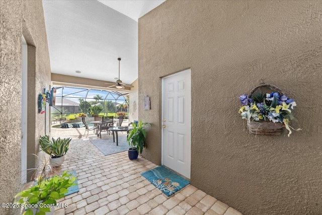 1350 Tamango Dr, Melbourne, FL 32904 - property entrance with stucco siding, a patio area, and outdoor dining space