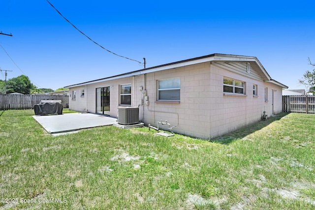 1426 Floyd Dr, Rockledge, FL 32955 - rear view of house with a patio, a fenced backyard, and concrete block siding