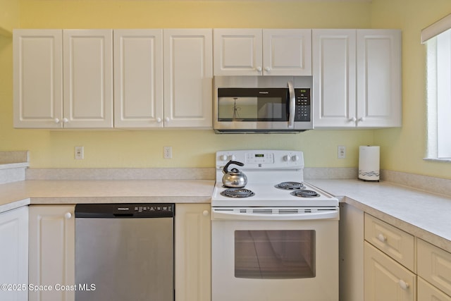 605 Ocean Park Ln Unit V235, Cape Canaveral, FL 32920 - kitchen featuring appliances with stainless steel finishes, light countertops, and white cabinetry