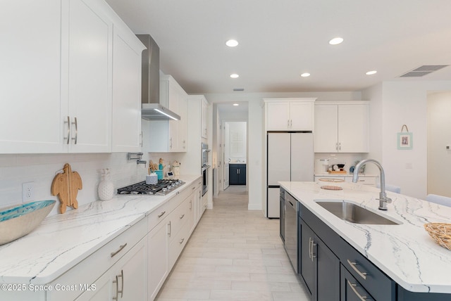 9124 Corvo Ct, Melbourne, FL 32940 - kitchen featuring appliances with stainless steel finishes, wall chimney exhaust hood, white cabinetry, recessed lighting, and backsplash