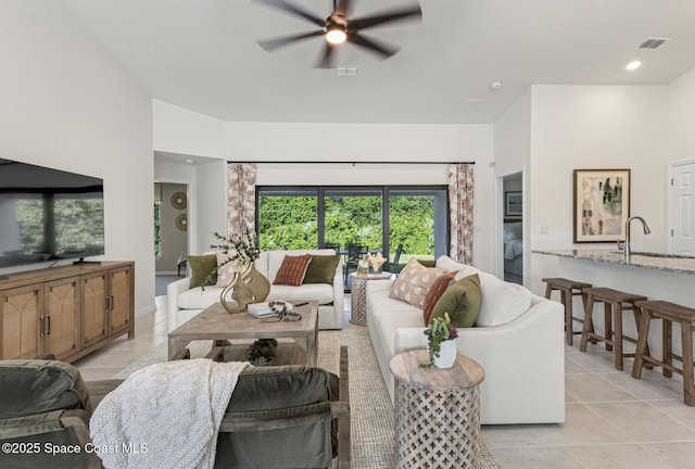 1011 Eldron Blvd SE, Palm Bay, FL 32909 - living area with ceiling fan and light tile patterned floors