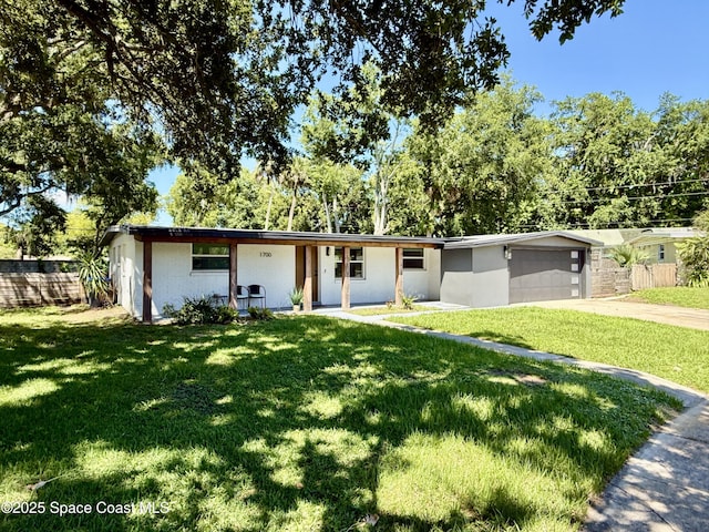 1700 N Lilac Cir, Titusville, FL 32796 - ranch-style house with covered porch, concrete driveway, an attached garage, and view of scattered trees